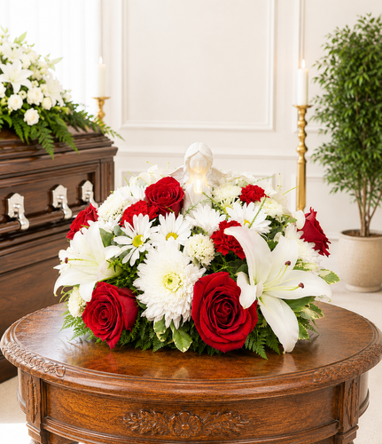 Custom color funeral pedestal arrangement featuring fresh seasonal flowers and greenery, professionally designed as a personalized sympathy tribute