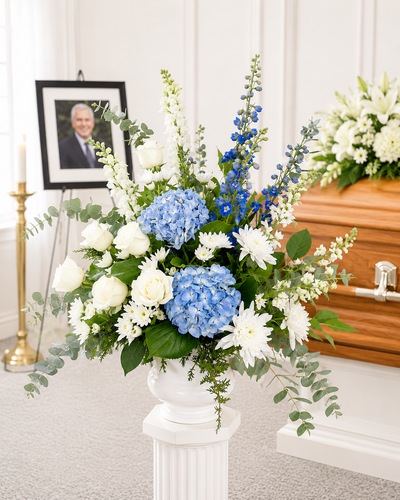 Elegant funeral pedestal flower arrangement displayed at a memorial service in Gilbertsville, PA