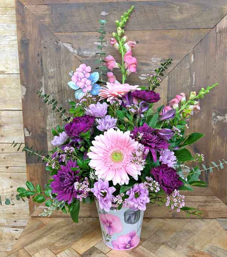 Luminous Petals Mother’s Day bouquet with pink and purple flowers in iridescent vase
