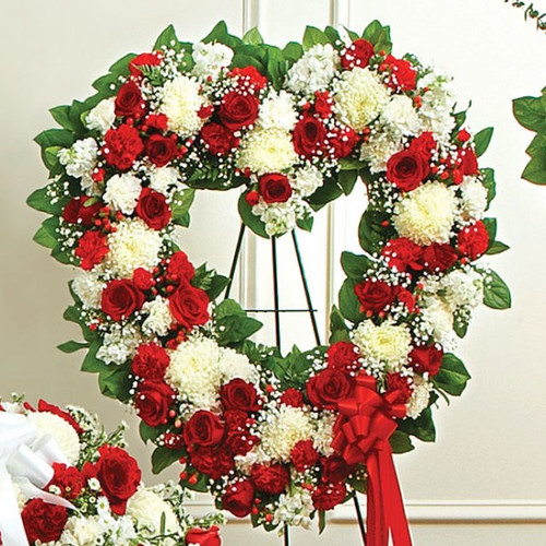Handcrafted heart-shaped standing spray with pink and purple flowers available for local delivery in Gilbertsville, PA