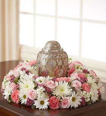 18-inch memorial urn wreath with white and pastel flowers in a celebration of life setting