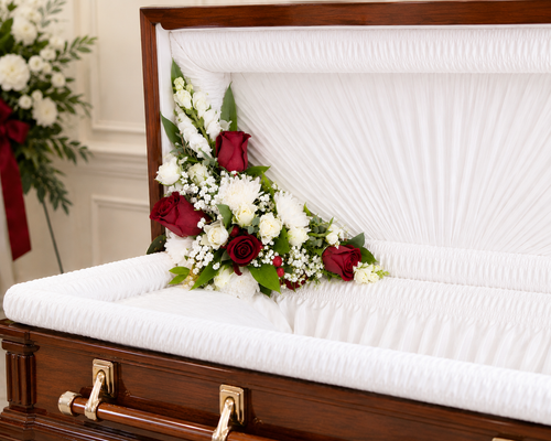 Red and white funeral casket corner flower arrangement inside an open casket in Gilbertsville, PA