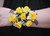 Yellow rose wrist corsage with soft greenery accents