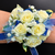 Rose wristlet corsage on wrist for formal dance