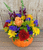 Fall flowers arranged in a ceramic pumpkin container