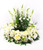 Funeral urn wreath centerpiece with hydrangeas, roses, and wildflowers in a memorial setting