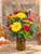 Scarecrow Sunshine fall flower arrangement with yellow gerbera daisies, autumn mums and scarecrow accent in an amber vase