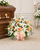 Funeral basket arrangement placed beside a casket featuring fresh seasonal flowers and greenery, custom designed by Wendy's Flowers in Gilbertsville, PA.