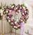 Heart-shaped funeral wreath with pink, lavender, and white flowers displayed at a memorial service in Gilbertsville, P