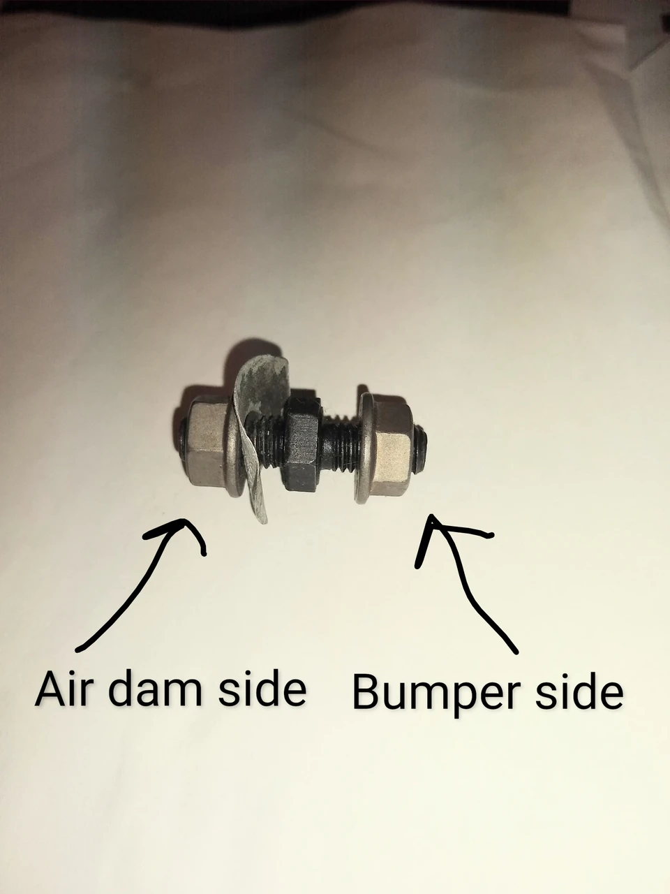 Air dam stud with flange nuts and spring steel washer assembled on stud