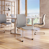 ofinto Flex Meeting Besucherstuhl ohne Armlehnen in modernem Konferenzraum - stapelbare Freischwinger in Weiß um weißen Meetingtisch mit Panoramafenster und natürlichem Lichteinfall