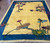 Angled, top facing image of antique Chinese carpet, showing a dimensional view of the rug in a room.