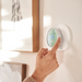 Person adjusting nest thermostat temperature on the wall Person adjusting nest thermostat temperature on the wall