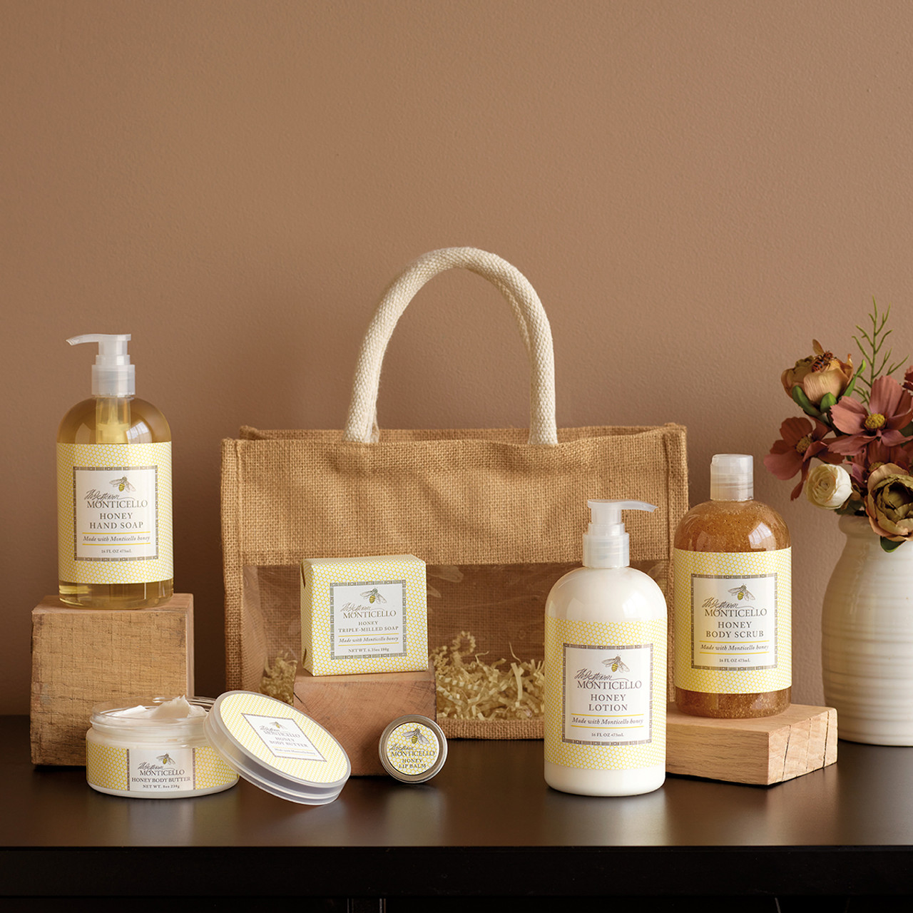 Bottles of skin care products arranged by fabric gift bag