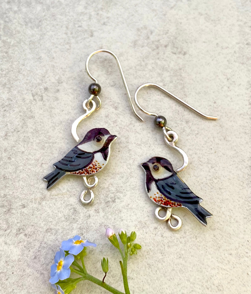 Who doesn't like the happy energy of the chickadee? These Chickadee Earrings are a tribute to this favorite bird. They are hand crafted out of Sterling silver and jeweler's brass, and then carefully handpainted. They measure 3/4" wide by 1" tall, not including the Sterling earring wire. They are light and comfortable to wear, and are the perfect gift for a friend or for you!