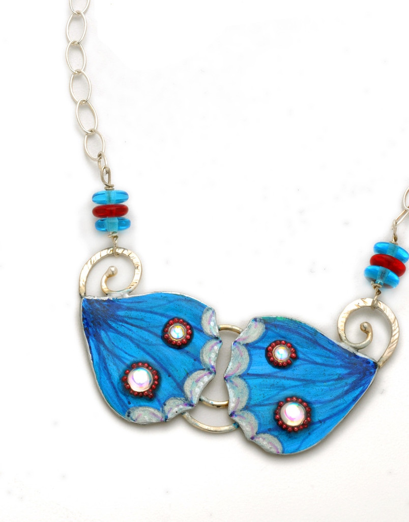 Blue Pansy Butterflies are yet one more example of the exquisite beauty of the natural world. These earrings are a tribute to them. They are handcrafted out of Sterling, jeweler's brass, carefully selected and applied color, and sealed with resin for durability. The necklace is 20" long, and can be adjusted to be worn shorter. It is light and colorful, and fun to wear and to give. 
