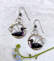 The sight and sound of a loon is always special, and these earrings are a reminder of that. They are handcrafted from jeweler's brass and Sterling silver, and carefully handpainted. They measure 7/8" x 1", and are light as a feather to wear.
