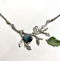 This necklace features a lovely piece of stone stack iron furnace slag that is set in silver and placed onto a handmade Sterling branch complete with caterpillar. I find the slag in a local river by a historical iron furnace (one of seven still standing!) but it could have come from countless other historical iron furnace sites across North America and Europe. The focal point measures 2 1/2" wide x 2" tall, and the total length of the necklace is 19". 