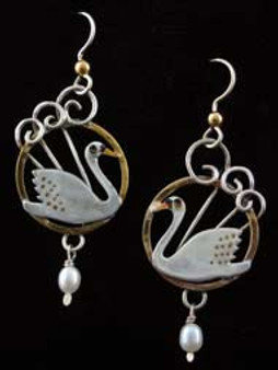 Swans are the quintessential graceful bird, and always amaze. So why not Swan Earrings as a reminder? These Swan Earrings are handcrafted out of Sterling and lacquered jeweler's brass. Dangling freshwater pearls give the earrings light movement. They measure 7/8" wide by 1 1/4" tall, not including the Sterling earring wires. 