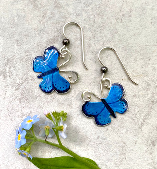  The karner blue butterfly is endangered due to the loss of its foodsource, the wild lupine, or lupinus perennis. Due to the efforts of school children replanting this native wildflower, the karner blue is making a come-back. These Karner Blue Butterfly Earrings are a tribute to this special butterfly, and to the efforts of these children. The earrings are handcrafted from jeweler's brass and Sterling silver, and carefully hand-painted. They measure 7/8" x 7/8" and are light as....what else?...a butterfly.