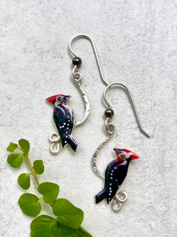 Pileated woodpeckers are a favorite bird. It is always a thrill to experience the flash of black, white and red, with the soundtrack of their loud calls and hammering. These earrings pay tribute to this special bird. They are hand crafted out of jeweler's brass and Sterling silver, and carefully hand colored. They measure 1/2" wide by 1" tall without their Sterling earring wires. They are light and comfortable to wear and make the perfect gift!