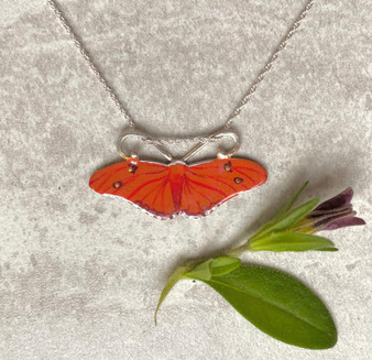 The Julia Butterfly, Dryas iulia, is a brush-footed butterfly. Its range is from Brazil to the southern US. It is often seen in butterfly houses, and perches on people sometimes. It is a lovely orange butterfly with color variation between individuals. This necklace is a tribute to this butterfly. It is fabricated out of Sterling and jeweler's brass, and carefully handpainted and then sealed with a coat of protective resin. It measures 1 3/8" by 5/8" tall and is suspended from a 16" Sterling chain, although it would also work on an 18" chain. If you would prefer the 18", please let me know in notes. 
