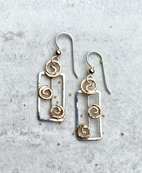 In these days of transitioning to best living practices for the conservation and the preservation of our planet, celebrating the vehicles that we are increasingly using for this goal seems both appropriate and even essential. It is in this spirit that Solar Panel Earrings were conceived. They are fabricated out of Sterling "grids" and embellished with 14k gold-filled swirls of energy-giving sunshine. They measure 1/2" wide by 1 1/8" tall, not including the Sterling earring wires. They are a lovely symbol of a movement that will ultimately save our planet. 