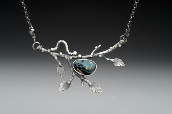 This necklace features a lovely piece of Stone Stack Slag that I found in the Gale River in Franconia, NH where I live. I set it on an oxidized Sterling branch, complete with leaves and a resident inchworm. It measures 19" long. 