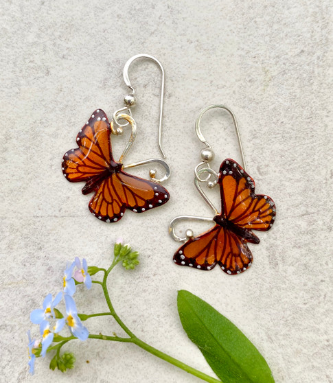 Monarchs and their migration are yet another marvel of the natural world. These Monarch Butterfly Earrings are a tribute to their beauty and fortitude. They are handcrafted from jeweler's brass and Sterling silver, and then carefully handpainted. They measure 7/8" x 7/8" and are light as a butterfly.