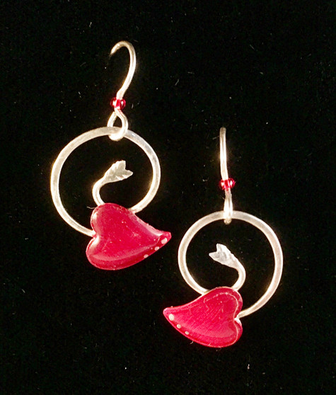 These Coiled Heart Arrow Earrings are the perfect way to wear your love. They are hand-crafted from Sterling silver and resined jeweler's brass. They measure 5/8" wide x 3/4" tall, not including the Sterling earring wires. They are light and fun to give and to wear!
