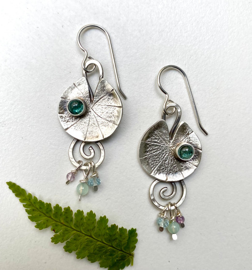 Anyone who has spent much time in a pond (highly recommend!) probably has an appreciation for lily pads. Between their plate-like leaves and those incredible flowers, what's not to love? These earrings celebrate a very special aquatic plant. I make them out of Sterling silver, and set a water-droplet-like topaz into each one, and then dangle little gemstone beads from them, for just a little more color...and then there's that fun motion! They measure 1/2" x 1 1/4", or 1 3/4" with their earring wires. They are light and comfortable to wear, and a reminder of those days when you hang with the frogs and turtles. 