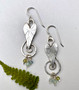 The arrowhead plant is a native marsh plant that does, indeed, have leaves shaped like arrowheads that spike out of the water. These earrings are a tribute to a cool plant that is fun to find. They are made out of Sterling, and dangle little gemstone beads; chrysophase, aquamarine and peridot. They measure 1/2" wide by 1 1/2" tall, 2" tall with the Sterling earring wires. 