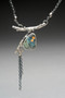 This necklace features a lovely piece of Stone Stack Slag that I found in the Gale River in Franconia. It could have come from anywhere that had an iron industry 200 years ago (and you would be surprised by just how many locations there are!). I polished this piece, and added a bit of gold mica powder melange, borrowing the Japanese concept of kintsugi, celebrating the broken. I then set it on a oxidized Sterling branch that I fabricated, and dangled small lengths of Sterling chain. They suggest spring flowering tree blooms. The necklace is 18" long, and brings together the beauty of nature with the fascination of local history and those who came before us. 