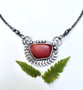 A lovely rosarita (gold slag from Alaska) that I cut and polished and then set in an oxidized Sterling fern-motif setting with an oxidized chain. The total length is 18". 