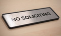 Brushed metal office and door signs with molded plastic frames