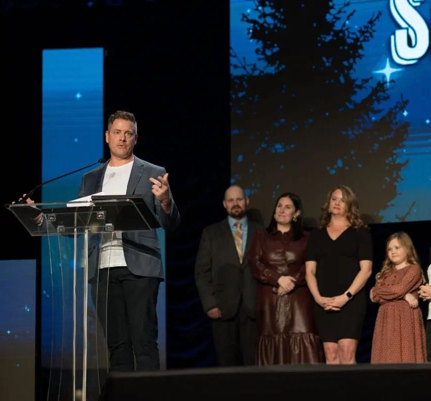 Ryan Fritz accepting Silver Medal with family on stage