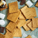 Graham crackers spread out with marshmallows and chocolate pieces.