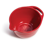 Red Emile Henry bowl with spout and handle at the rim. The angle of the image is looking down into the bowl.