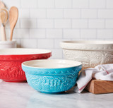 3 bowls, side by side on counter top with wooden utensils in the background. Red horse bowl, white pig bowl, blue chicken bowl.