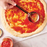 pizza sauce spreading on pizza with Pizza Sauce Spoon