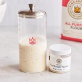 Fresh Sourdough Starter and Petite Sourdough Crock Set on a counter top with a bag of King Arthur All-Purpose flour