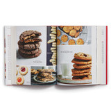 The Essential Cookie Companion open to images of magic in the middle, rye chocolate chip cookies, and others.