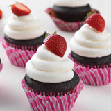 Chocolate cupcakes with vanilla frosting, topped with a strawberry made with Deliciously Simple Chocolate Cake Mix