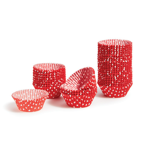 Red cupcake papers with white polka-dots. Stacked in various heights.