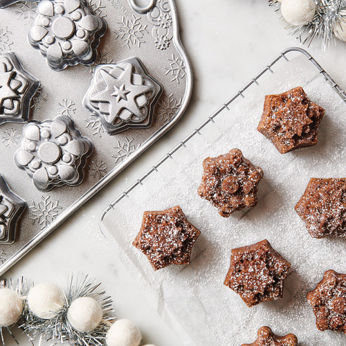 Gingerbread cake mix made in the Snowflake cakelette pan. The cakelettes have a light dusting of powdered sugar.