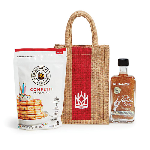Sweet and Sparkly Pancake Gift including Confetti Pancake Mix, Sparkling Maple Syrup, and tan jute gift bag with red stripe and king arthur baking logo.