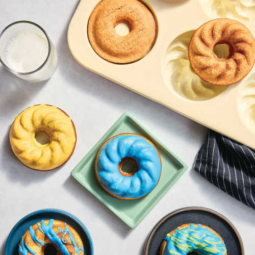 Buttermilk doughnut mix made in the French twist doughnut pan. Topped with melting morsels in green, blue and yellow.