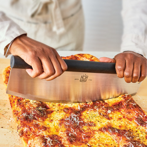 Pizza Rocker being used to slice pizza