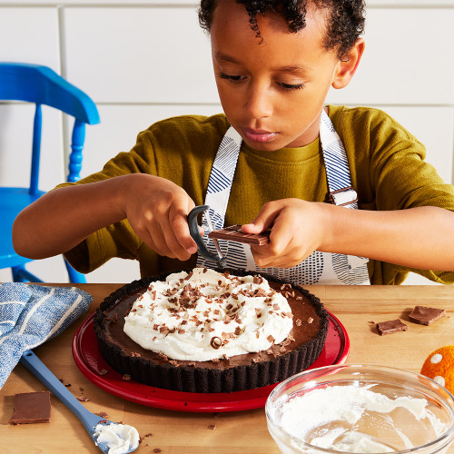 A young baker making a chocolate cream pie