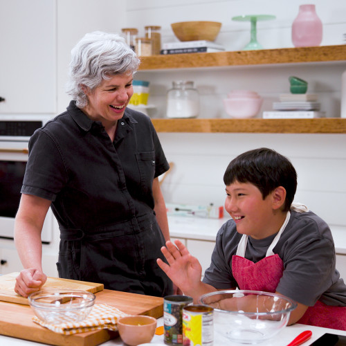 Young baker and instructor making empandas